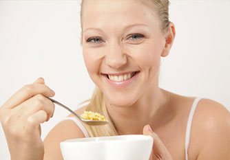 Woman-Eating-Cereal - Trapped Food Causes Oral Problems in South Jordan, UT