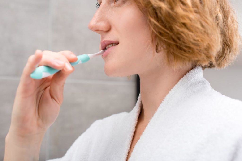Female Cleaning Teeth